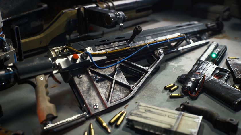 Arc Raiders attachments: A close-up shot of a makeshift gun with wires attached to it on a workbench, with other guns and ammo scattered around.