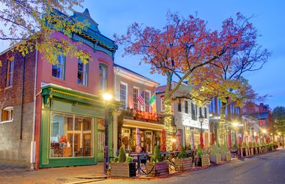 Storefronts in Old Town Alexandria, Virginia, at dusk in autumn