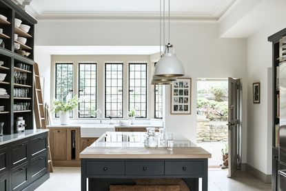 Bright kitchen with white walls and black and natural wood cabinets