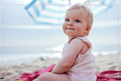 Toddler sat on the beach