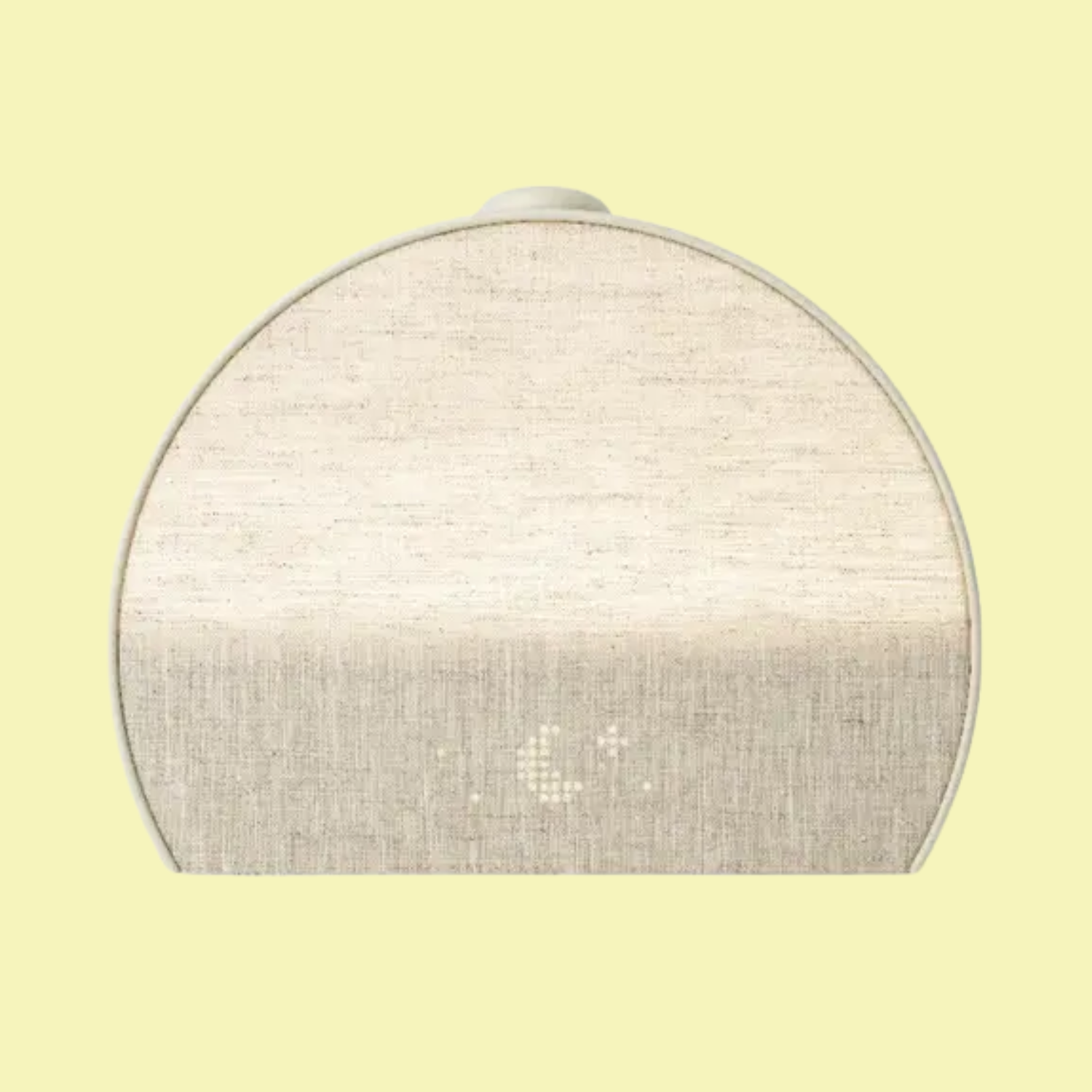 A beige alarm clock and sound machine