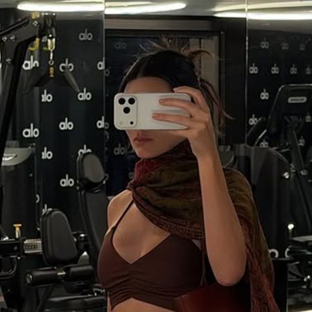 kendall wears a brown scarf and brown sports bra.