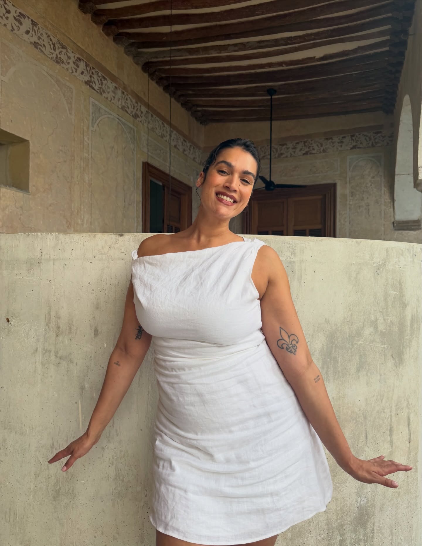 Jennifer wears a white minidress.