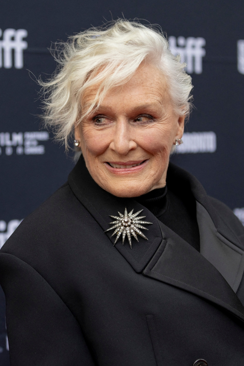 Glenn Close poses on the red carpet wearing a black coat and with a side-swept pixie style haircut, in Toronto, Canada, on September 6, 2025. The actress plays Martha Delacroix in Rian Johnson&#039;s new film, presented at the Toronto International Film Festival.