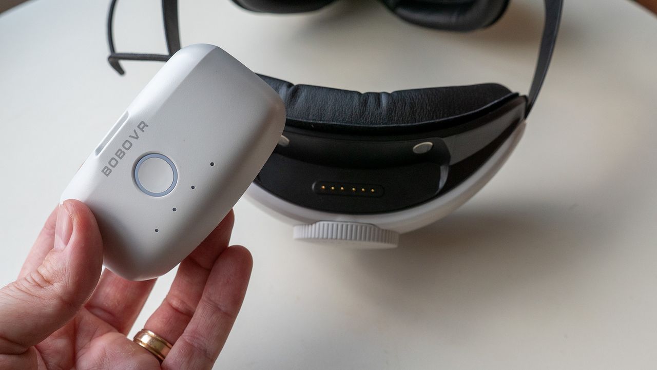 Holding the battery of the BoboVR M2 battery head strap for the Meta Quest 2