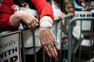 A woman shows off her Trump-branded bracelet at a campaign rally in Radford, Virginia
