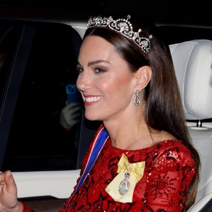 Kate Middleton wearing a red sequin gown riding in a car 