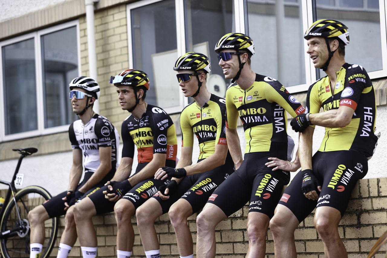 Picture by SWpix.com - 08/09/2021 - Cycling - AJ Bell Tour of Britain Stage 4 - Aberaeron to Great Orme, Llandudno, England - Team Jumbo Visma sit on a wall as they wait for Stage 4 to begin.