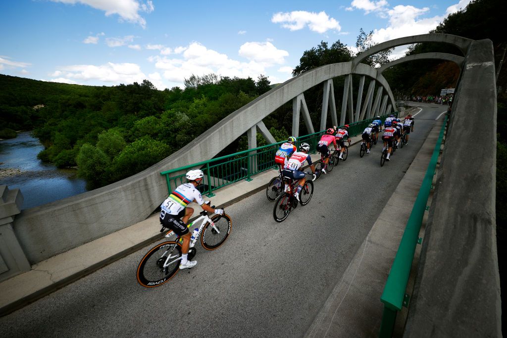NMES FRANCE JULY 08 Julian Alaphilippe of France and Team Deceuninck QuickStep Edward Theuns of Belgium and Team Trek Segafredo Edvald Boasson Hagen of Norway and Team TotalEnergies the Breakaway passing through a bridge during the 108th Tour de France 2021 Stage 12 a 1594km stage from SaintPaulTroisChateaux to Nimes LeTour TDF2021 on July 08 2021 in Nmes France Photo by Chris GraythenGetty Images