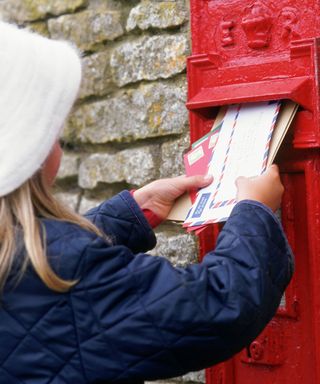 girl is posting envelopes