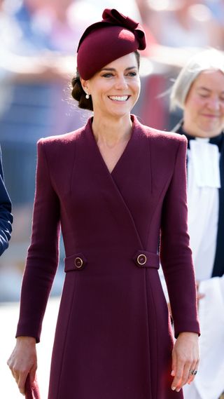 Kate Middleton in a berry coloured tailored dress and hat