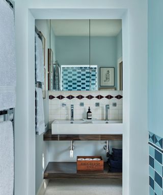 Blue walls, white backsplash tiles, wooden shelves