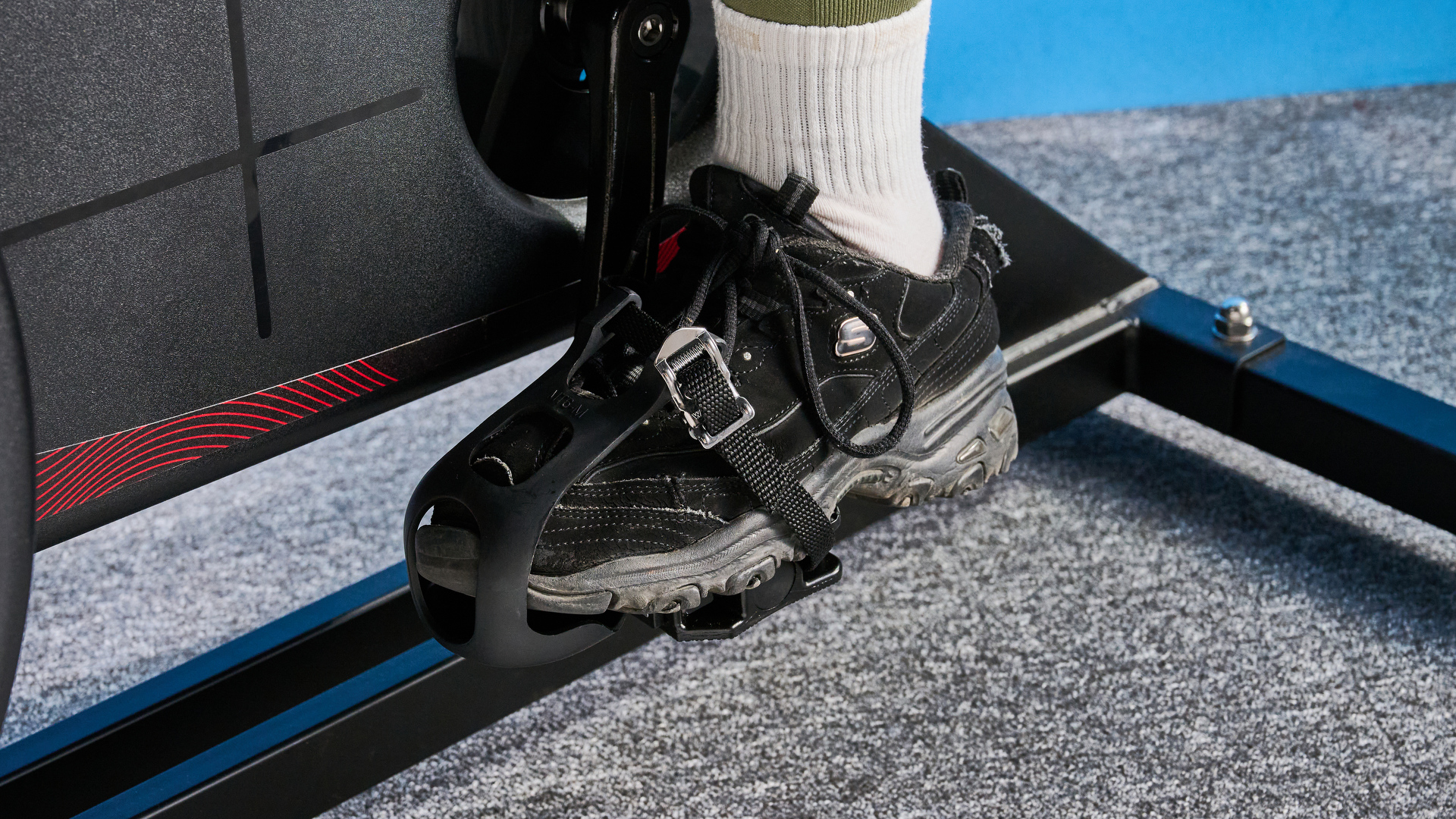 the wattbike air with a black and white front wheel, adjustable seat, and phone holder with app compatibility
