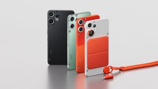 Four Nothing CMF Phone 2 Pro units back-to-back in black, green, orange, and white on a gray table
