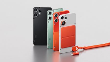 Four Nothing CMF Phone 2 Pro units back-to-back in black, green, orange, and white on a gray table
