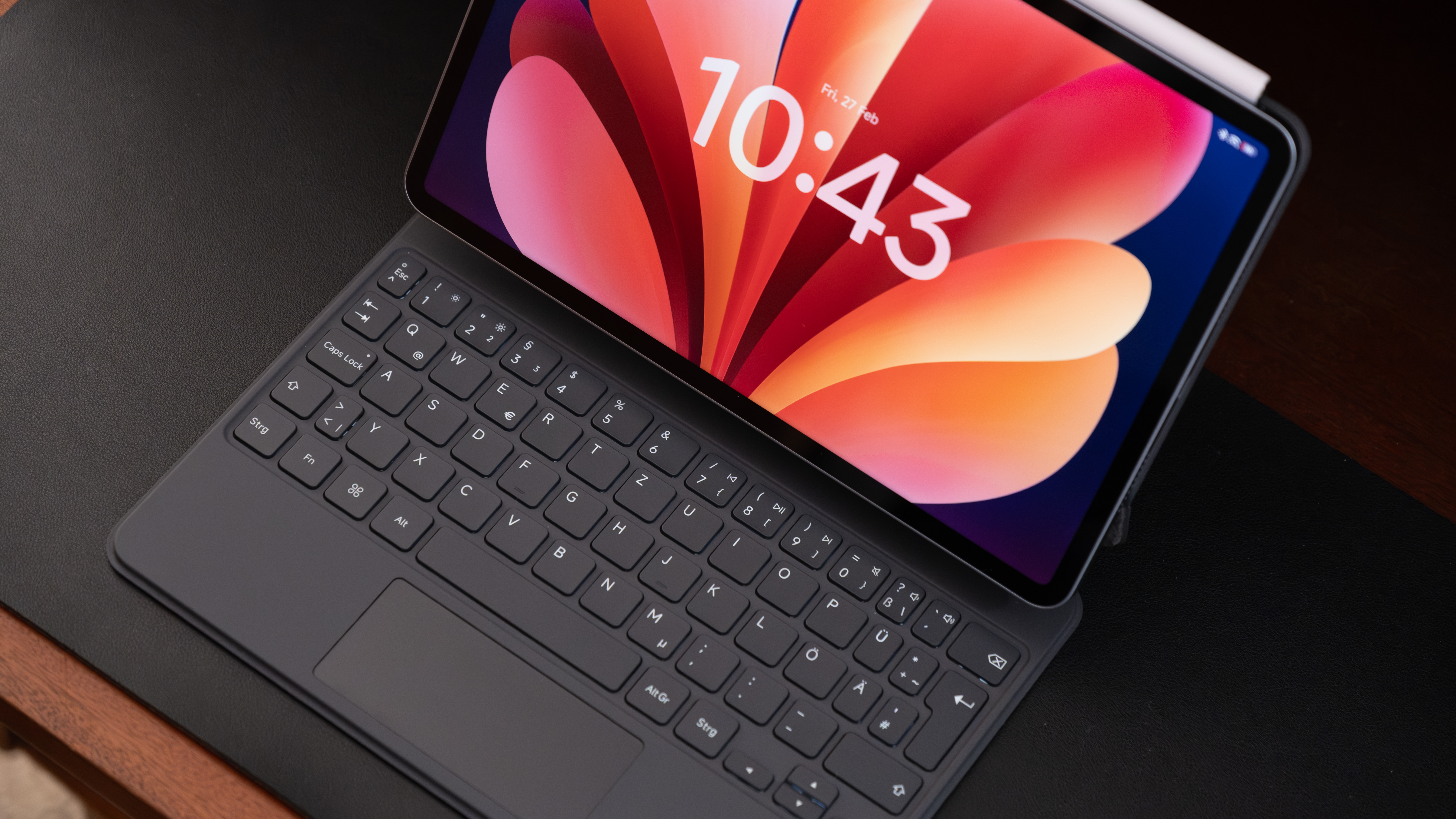 Top-down close-up of the Xiaomi Pad 8 Pro keyboard case, showing the large trackpad and chiclet-style keys beneath the display.