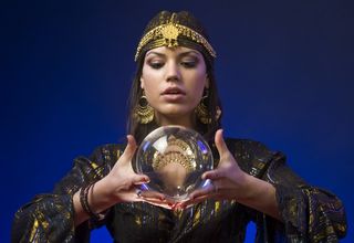 A fortune-teller holds a crystal ball.