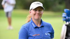 Gemma Dryburgh wearing a blue polo and white cap during an LPGA event