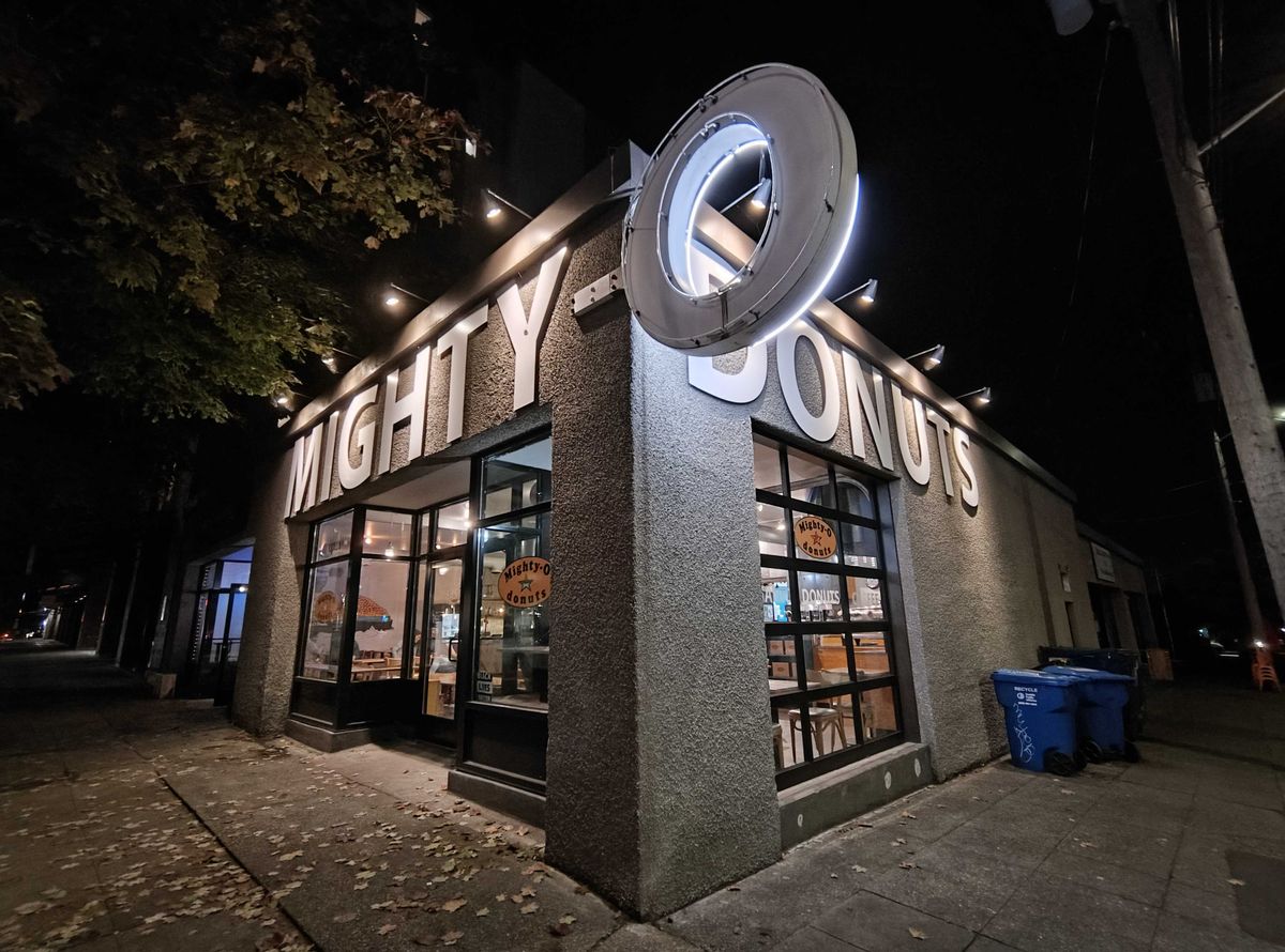 A donut shop sign at night