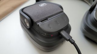 The Yamaha YH-L700A headphones being charged