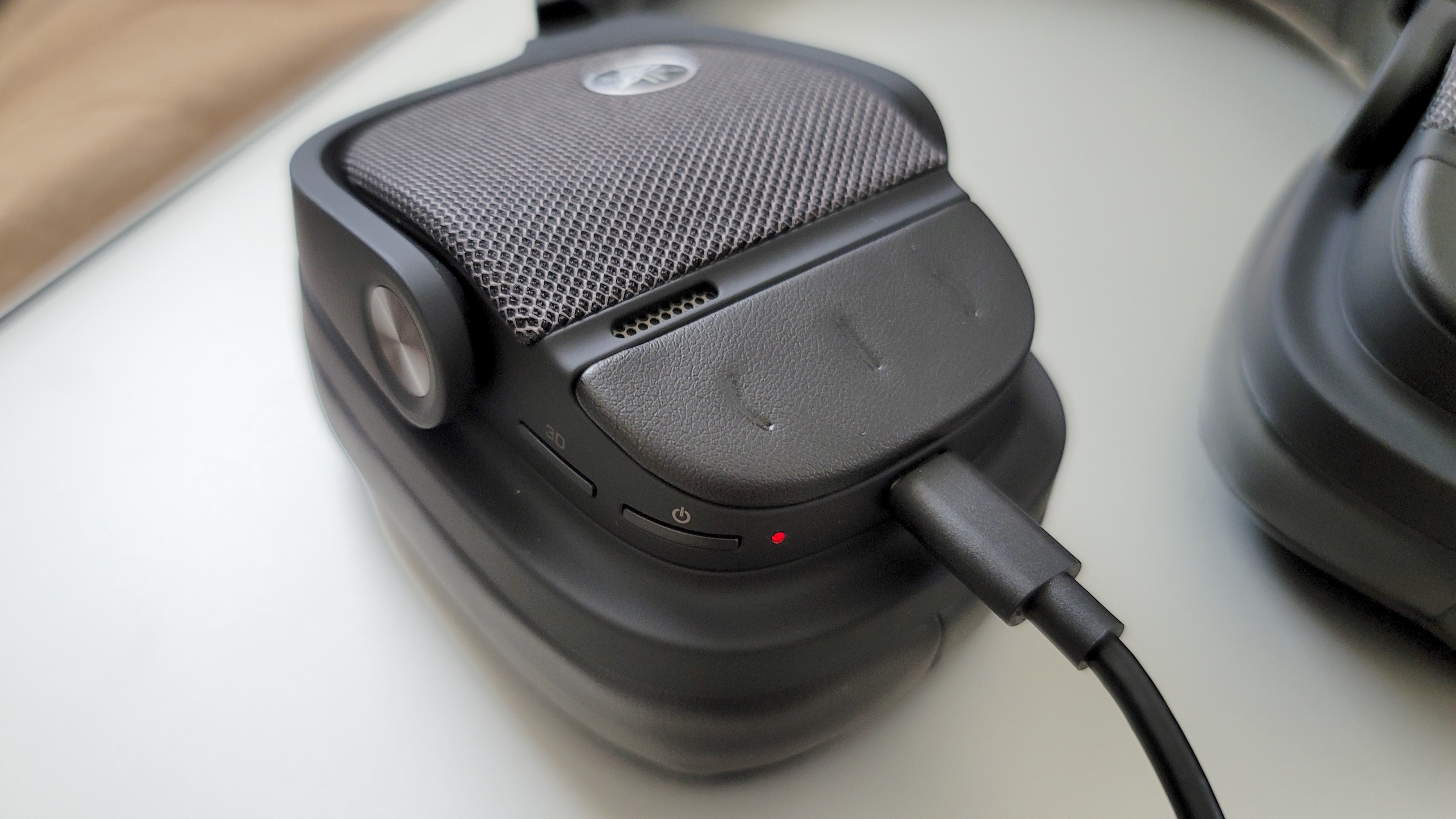 The Yamaha YH-L700A headphones being charged