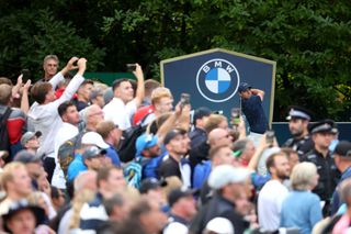 Rory McIlroy hits a shot in front of a huge crowd