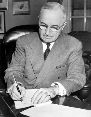 President Truman signing a proclamation declaring a national emergency and authorizing U.S. entry into the Korean War.