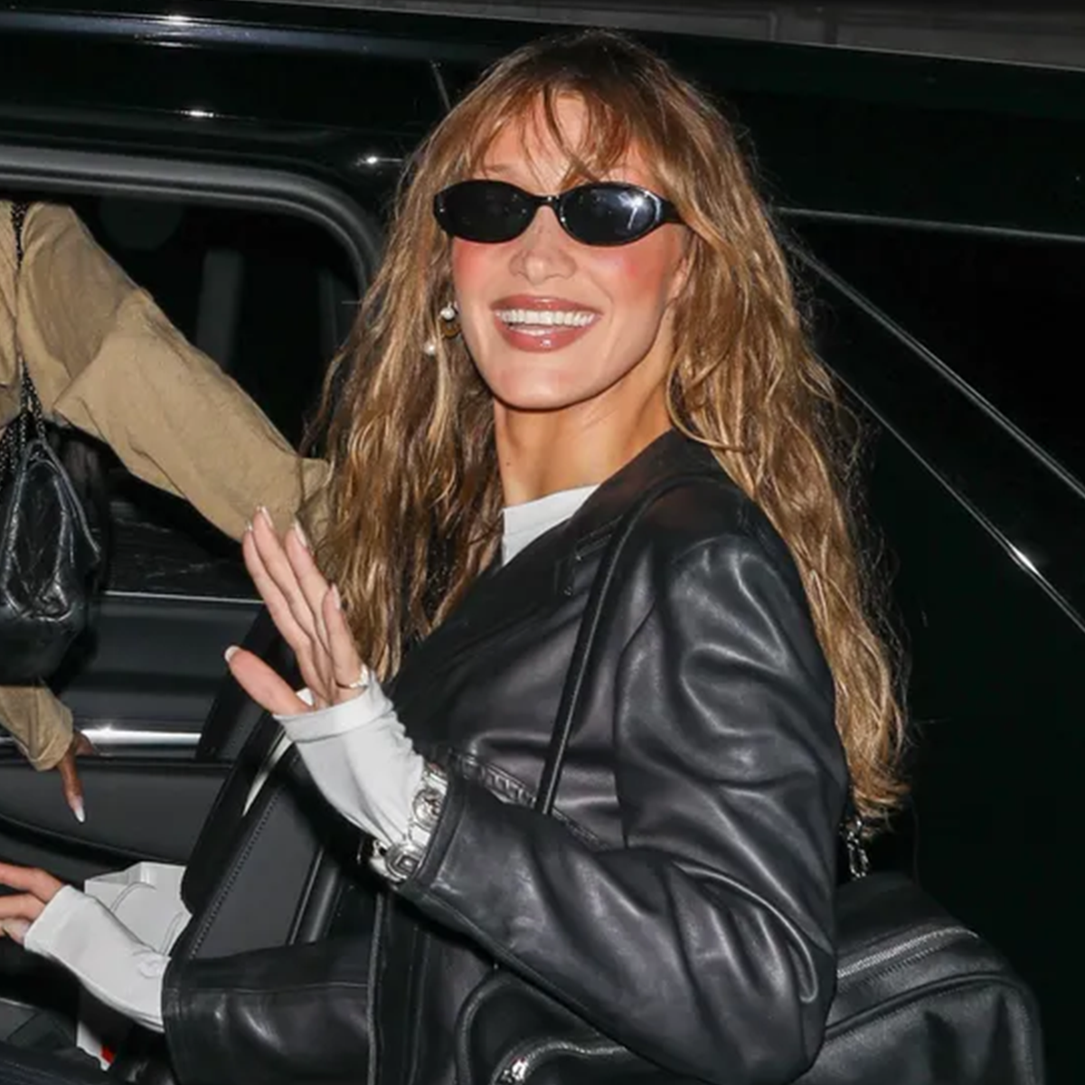 an image of Bella Hadid carrying a Loewe Amazona 180 Bag