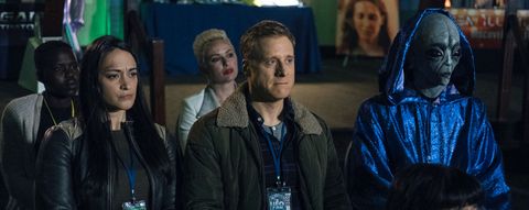 Asta (Sara Tomko) and Harry (Alan Tudyk) visit a UFO convention in order to find the alien technology that he needs to complete his doomsday device in Resident Alien.