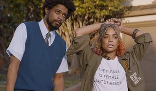 Sorry To Bother You Lakeith Stanfield Tessa Thompson standing around looking bored