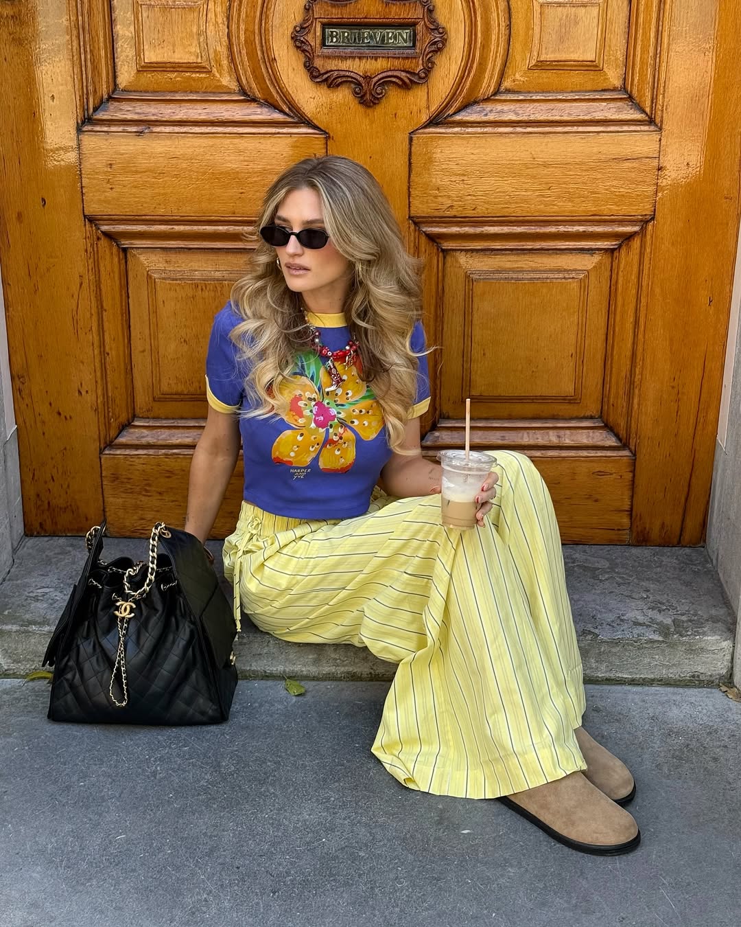 Tessa Van Montfoort wears yellow trousers graphic floral t-shirt