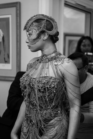 Megan Thee Stallion gets ready for the Gaurav Gupta haute couture show in Paris wearing a chainmail bodysuit and headpiece