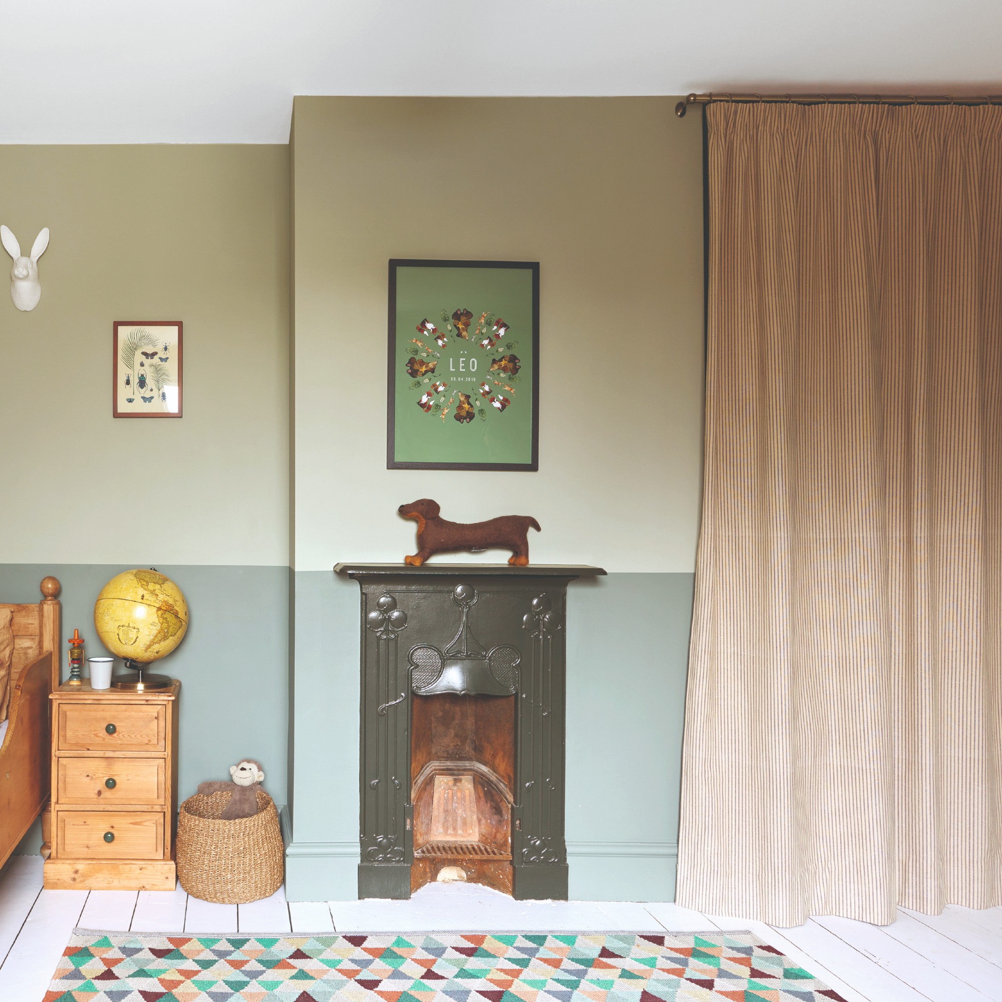 A kid's room with two-toned walls painted in different shades of earthy green