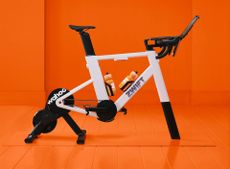The Zwift Ride with KICKR CORE 2 side on with orange background