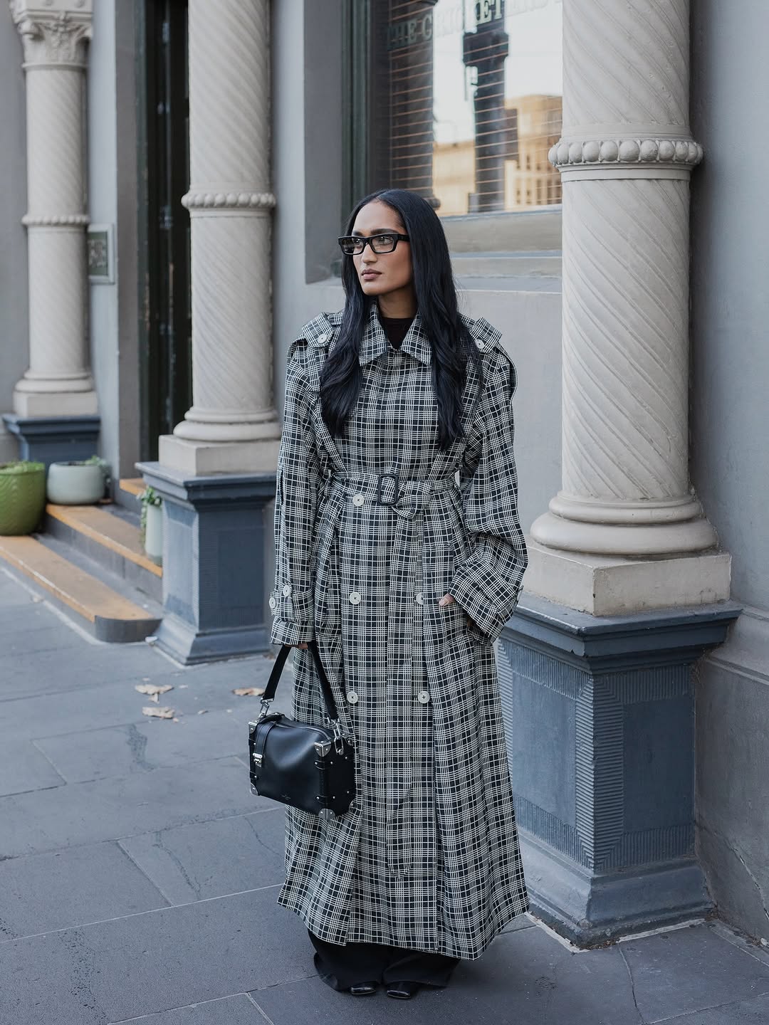 Woman wearing plaid jacket trend fall 2025.
