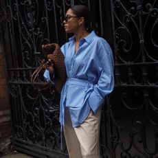 Woman wears striped shirt and tailored trousers