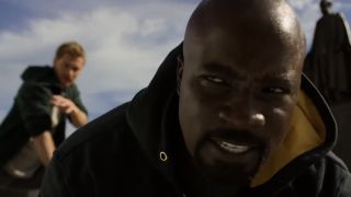 Luke Cage (Mike Colter) is hit by Danny Rand on Luke Cage