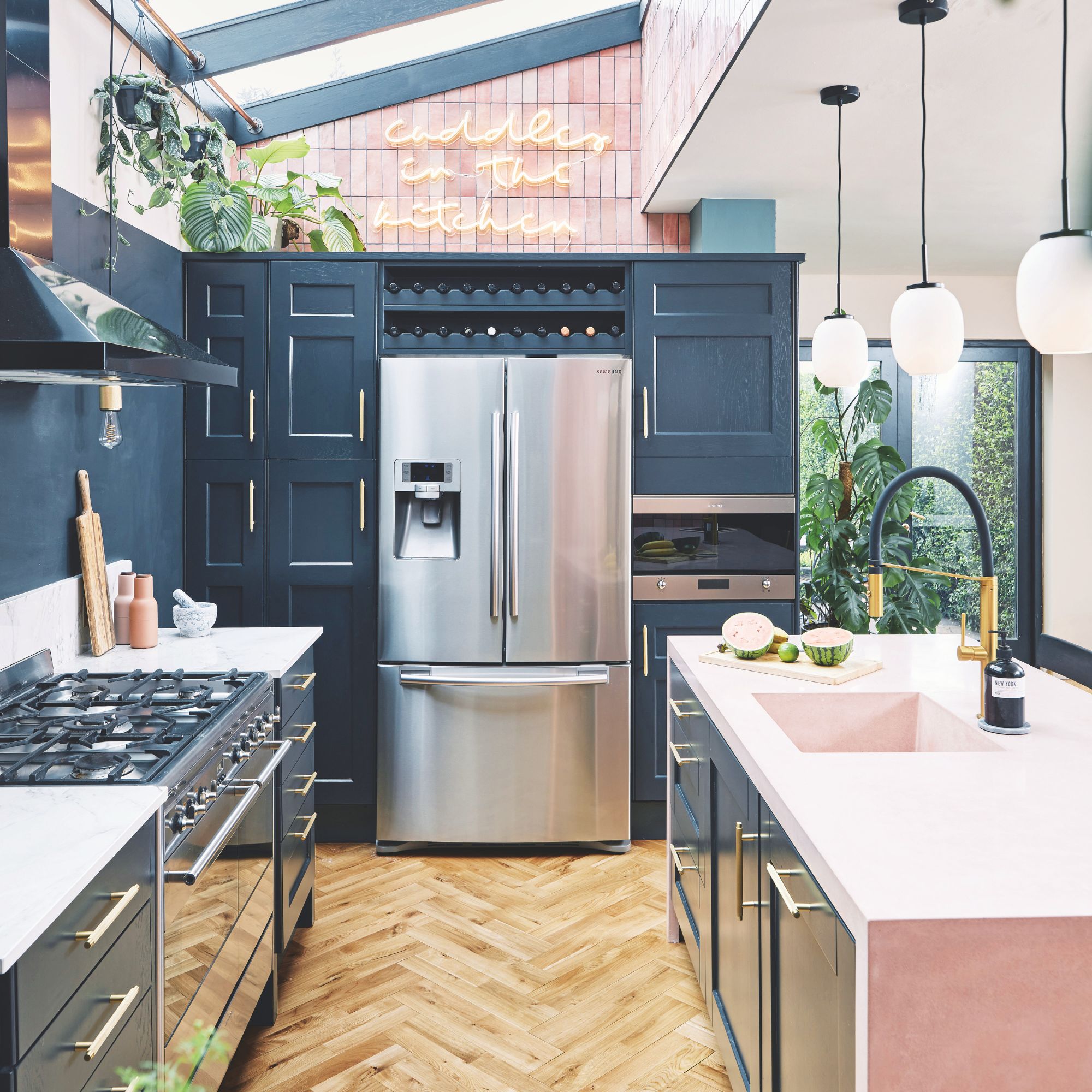 Kitchen with blue cabinets and a large fridge-freezer in the middle