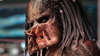 A close-up shot on an alien with dreadlock-esque hair and four mandibles around its mouth.