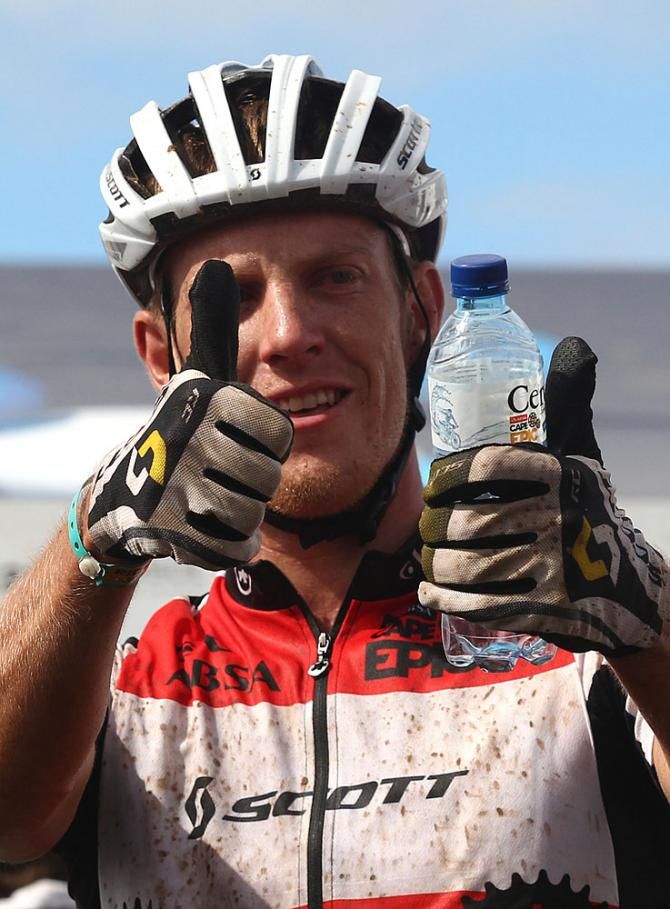 Matthys Beukes of SCOTT Factory Racing gives a thumbs up after winning the final stage with patner Gert Heys