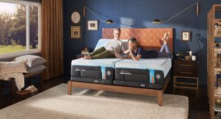 A couple lay upon the Tempur-Pedic Tempur-Ergo Smart Base bed