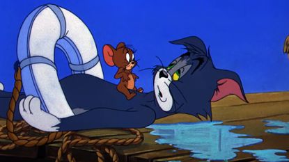 Tom, recently saved from drowning, looks groggily up at Jerry in a Tom and Jerry cartoon