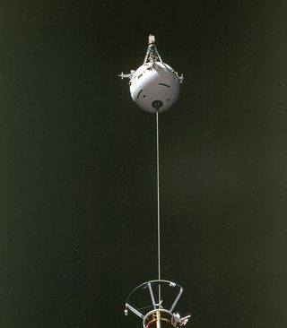 The Tethered Satellite System (TSS) being deployed from the space shuttle Atlantis during STS-46 in 1992. The photo was taken from onboard the shuttle.