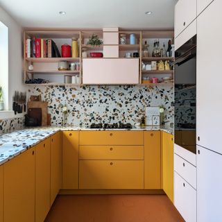 Yellow kitchen with terrazzo splashback
