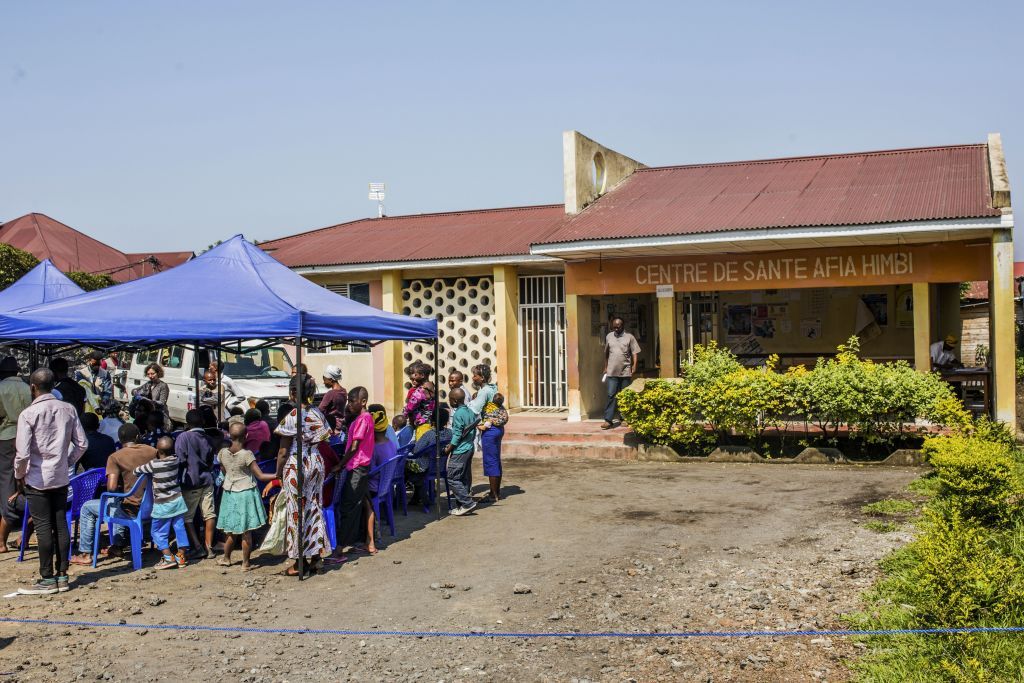 Patients wait outside the Afia Himbi Health Center on July 15, 2019 in Goma