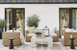 A wicker-effect outdoor sofa and lounge chairs