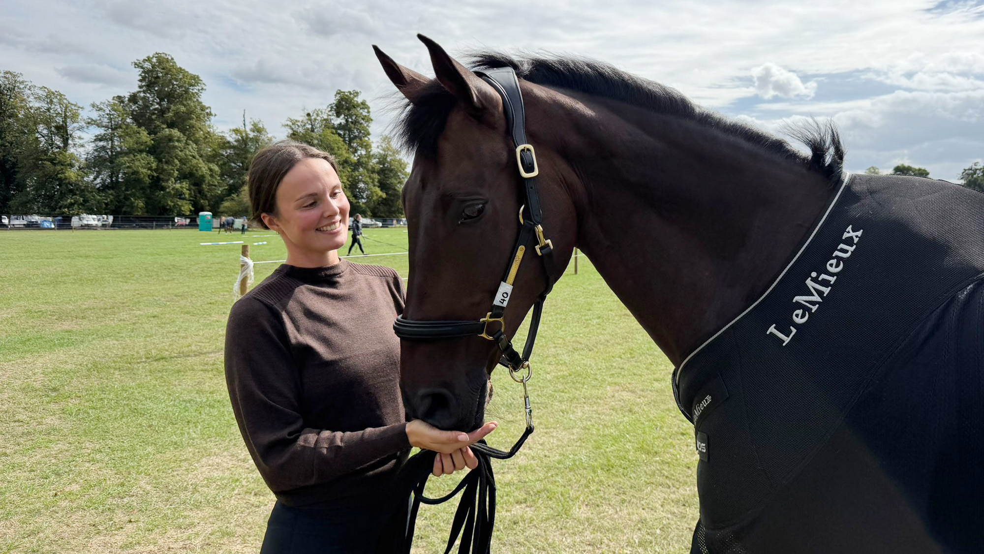 Jess Elliott (groom to Austin O&rsquo;Connor), wearing a brown jumper, and Sixmilewater, a horse wearing a rug with LeMieux on it