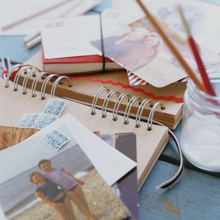 scrap book with photographs and postal tickets