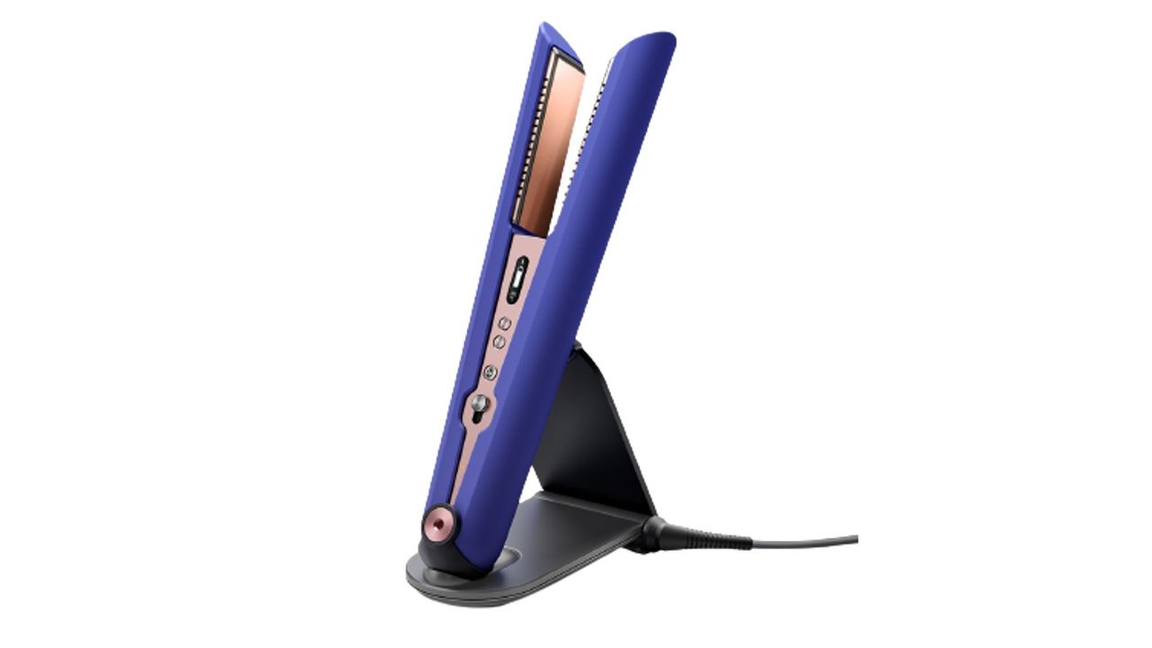 The Dyson Corrale Hair Straighteners plugged into its charger, with a spare wire beside it