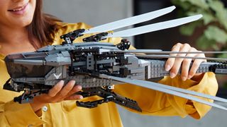 A woman holds the Lego Ornithopter